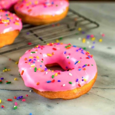 Fresh pink doughnuts with colourful sprinkles